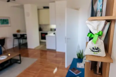 a bag hanging on a wall in a living room at WellNest Niš Self Check-in & Parking I Moderan, miran apartman plus radni kutak in Niš