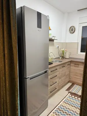 a stainless steel refrigerator in a kitchen at Nest24- cozy apartment with terrace and private garage in Niš