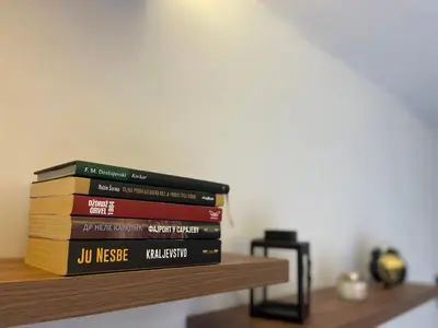 a stack of books sitting on a shelf at Evergreen Lux in Kopaonik