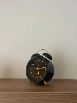a black alarm clock sitting on top of a table at Evergreen Lux in Kopaonik