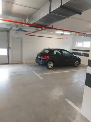 a car parked in a parking lot in a garage at Bagdala apartman Krusevac in Kruševac