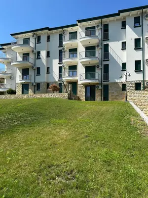 an apartment building with a large lawn in front of it at Lux stay in Vrnjacka Banja C3 in Vrnjačka Banja