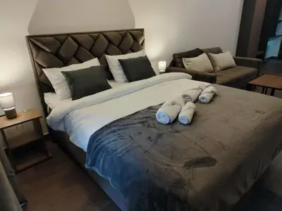 a large bed with three pillows on top of it at Minalux i MInalux1 in Kopaonik