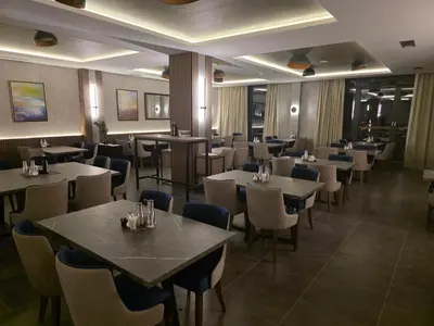 a restaurant with tables and chairs in a room at Minalux i MInalux1 in Kopaonik