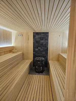 a sauna with a table in the middle of it at Minalux i MInalux1 in Kopaonik