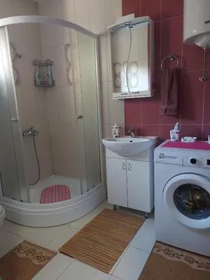 a bathroom with a washing machine and a sink at Studio apartman BB4 in Vrnjačka Banja
