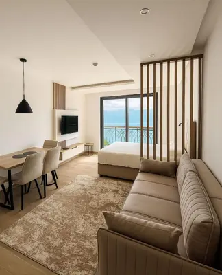 a living room with a couch and a bed and a table at Hafsah Hill Kopaonik in Kopaonik