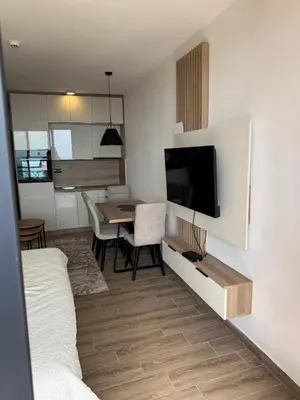 a living room with a television and a dining room table at Hafsah Hill Kopaonik in Kopaonik