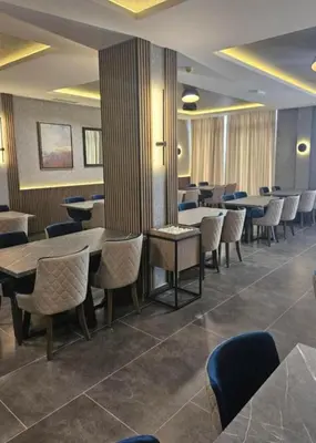 a dining room with tables and chairs and tablesktop at Hafsah Hill Kopaonik in Kopaonik