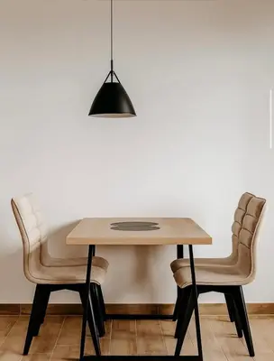 a dining room table with two chairs and aendant light at Hafsah Hill Kopaonik in Kopaonik
