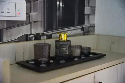 a black tray with a bottle and cups on a kitchen counter at Apartman Sanja in Džavarci