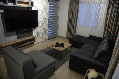 a living room with a couch and a flat screen tv at Apartmens in Kopaonik in Kopaonik