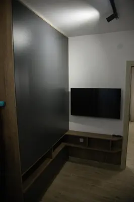 a living room with a flat screen tv on a wall at Apartmens in Kopaonik in Kopaonik