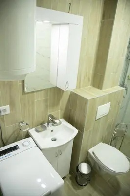 a bathroom with a sink and a toilet and a mirror at Apartmens in Kopaonik in Kopaonik