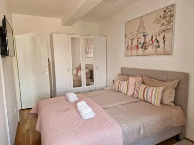 a bedroom with a bed with two towels on it at Apartman IRIS in Pirot