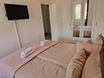 a bedroom with a bed with two towels on it at Apartman IRIS in Pirot