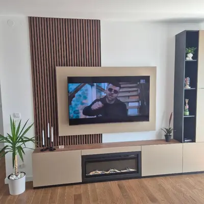 a living room with a tv and a fireplace at V i N Boutique Apartment in Niš
