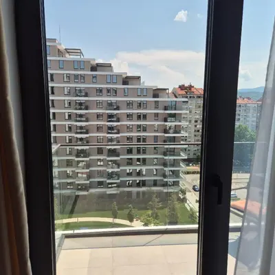 a view of a large building from a window at V i N Boutique Apartment in Niš