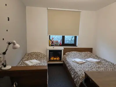 a bedroom with two beds and a fireplace at Snow White apartman Vila Bela reka 50m from gondola - free parking in Brzeće