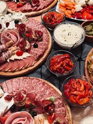a table with many different types of pizzas on it at Motel Kruna in Despotovac