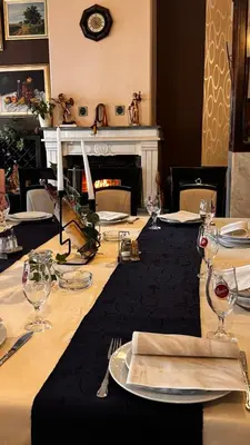 a long table with plates and wine glasses on it at Motel Kruna in Despotovac