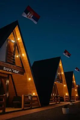 a building with black triangles on it at night at Vile NIT in Raška