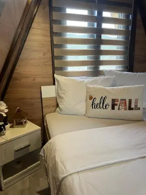a bedroom with two beds and a pillow with hello fall at Vile NIT in Raška