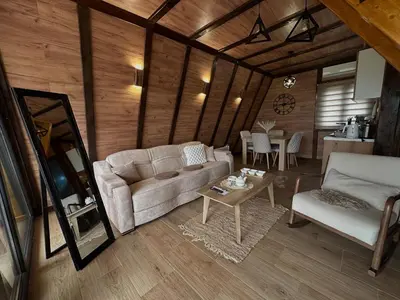 a living room with a couch and a table at Vile NIT in Raška
