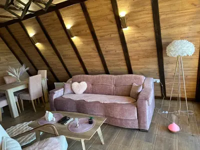 a living room with a couch and a table at Vile NIT in Raška