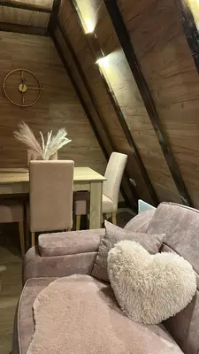a living room with a couch and a table at Vile NIT in Raška