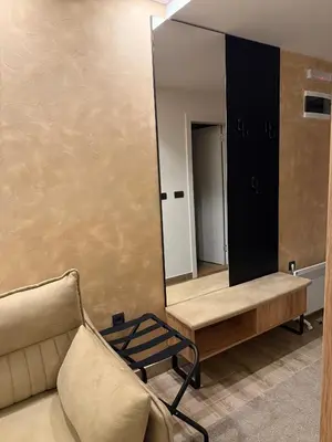 a living room with a mirror and a couch at UN lux - Residence Hill in Kopaonik