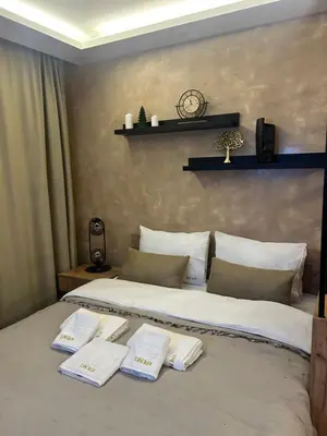 a bedroom with a bed with two towels on it at UN lux - Residence Hill in Kopaonik