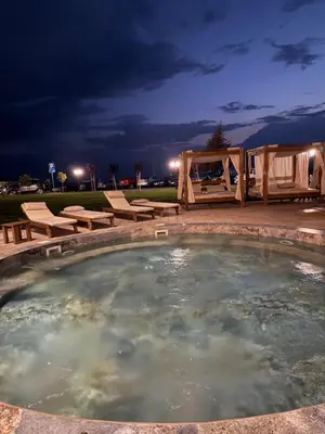 a hot tub in a backyard at night at UN lux - Residence Hill in Kopaonik