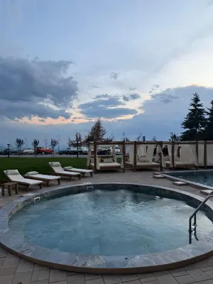 a large pool with lounge chairs around it at UN lux - Residence Hill in Kopaonik