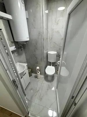 a small bathroom with a toilet and a sink at Sweet home in Bor