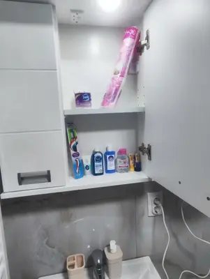 a bathroom with a shelf above a sink at Sweet home in Bor
