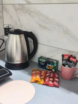 a kitchen counter with a tea kettle and some snacks at Sweet home in Bor