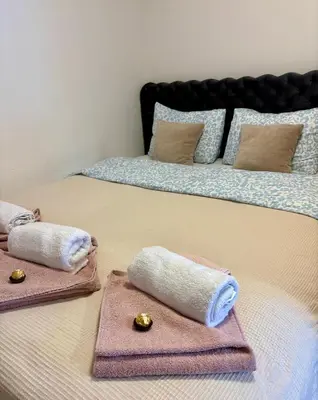 two towels are sitting on top of a bed at Aurora Lux in Vrnjačka Banja