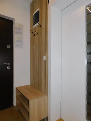 a room with a door and a drawer and a tv at Aurora Lux in Vrnjačka Banja