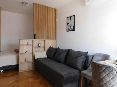 a living room with a couch and a bed at Aurora Lux in Vrnjačka Banja