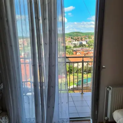 a window with a view of a city at Apartman PK Vrnjačka Banja in Vrnjačka Banja