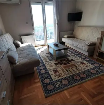 a living room with a couch and a coffee table at Apartman PK Vrnjačka Banja in Vrnjačka Banja