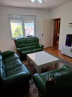 a living room with green leather couches and a table at Modern Spacious ViS Raska Apartment! 5min Cafes in Raška