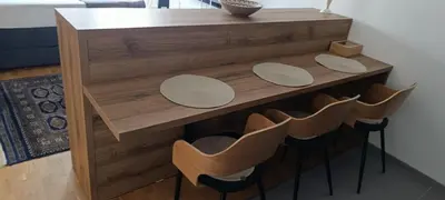 a wooden counter with four chairs and a table at Apartman Seka in Vrnjačka Banja