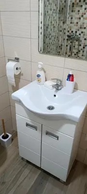 a bathroom with a white sink and a mirror at Apartman Seka in Vrnjačka Banja