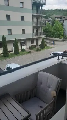 a couch on the balcony of a building at Apartman Seka in Vrnjačka Banja