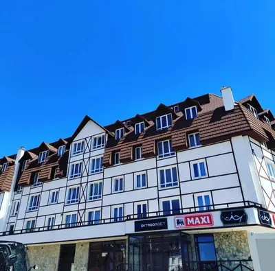 a large white building with a brown roof at Studio Kruna Kopaonik in Kopaonik