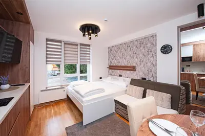 a small room with a bed and a table at Studio Kruna Kopaonik in Kopaonik