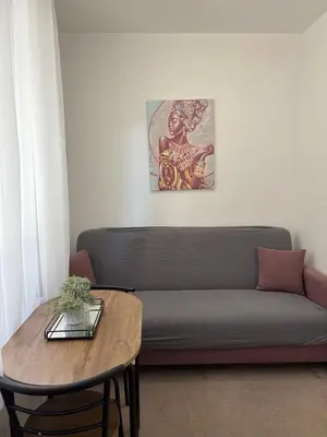 a living room with a couch and a table at Wing Apartman Jagodina in Jagodina