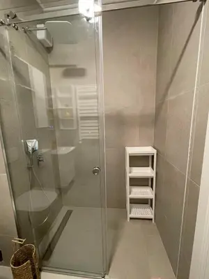 a bathroom with a shower with a glass door at Skyline Lux Apartment by Planet Residence in Niš